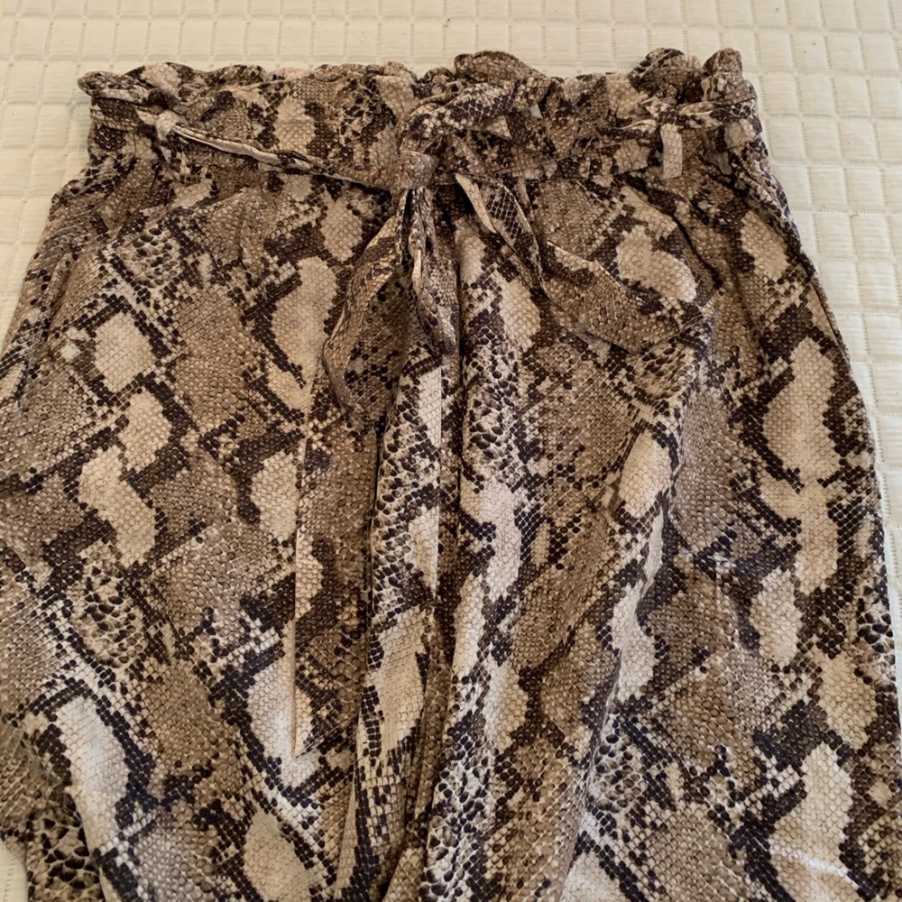 Paper bag waist snake skin trousers.
